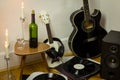 Rock'n'roll setup with ukulele, acoustic guitar, speaker, candle Royalty Free Stock Photo