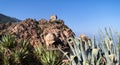 A rock with an old defensive stone tower above sea level in the city of Porto on the island of Corsica in France. Royalty Free Stock Photo