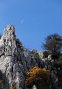 Rock outcroppings in autumn, with the moon Royalty Free Stock Photo