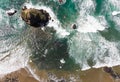Rock in the Pacific Ocean, waves and the beach, stones. Top view, blue water Royalty Free Stock Photo