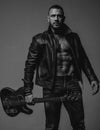 Rock this party. Muscular athletic sexy male with guitar. Confident and handsome brutal man play music. Party for adults