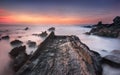 The rock path to the ocean, regarding a colorful sunset