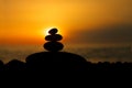 Rock pebble pyramid silhouette at sunset, zen stones, balance Royalty Free Stock Photo