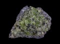 Rock with peridot olivine mineral from the USA isolated on a pure black background Royalty Free Stock Photo