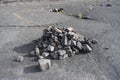 Rock pile marking a trail along a desolate stone backdrop