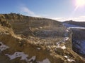 A rock quarry is uncovered as spring begins