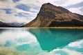 The rock is reflected in emerald lake Royalty Free Stock Photo