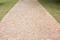 Concrete and rough rock road in the park. Concrete pavement in the park