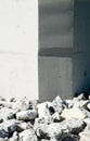 Rock rubble by corners of smooth vertical wall. Royalty Free Stock Photo