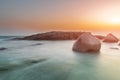 The rock and the sea in the color of sunset time Royalty Free Stock Photo