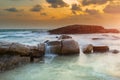 The rock and the sea in the color of sunset time Royalty Free Stock Photo