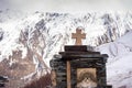 Rock shrine with snowy Caucasus mountains in the background