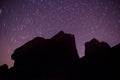 Rock silhouette and star trails round polaris Royalty Free Stock Photo