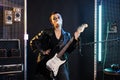 Rock singer blowing bubble gum while posing in studio in isolated background Royalty Free Stock Photo