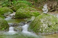 Rock stack, next to a wild stream, a pile of stacked rocks