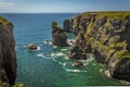Rock stacks offshore viewed from the top of a secluded cove along the Pembrokeshire coast, Wales Royalty Free Stock Photo