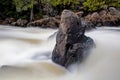 Rock Stands Solid In The Turbulent Waters Of Ragged Falls Royalty Free Stock Photo