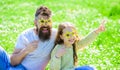 Rock star concept. Dad and daughter sits on grass at grassplot, green background. Family spend leisure outdoors. Child Royalty Free Stock Photo