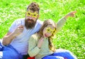 Rock star concept. Family spend leisure outdoors. Father and daughter sits on grass at grassplot, green background Royalty Free Stock Photo