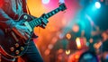 Rock star playing the electric guitar on stage with lights in the background