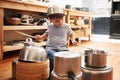 Rock star in the making. A young boy playing drums on pots and pans. Royalty Free Stock Photo