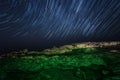 Rock. starry night sky. sea. Sea highlighted . star trails Royalty Free Stock Photo