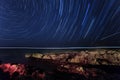 Rock. starry night sky. sea. star trails. polaris star Royalty Free Stock Photo