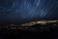 Rock. starry night sky. sea. star trails. polaris star Royalty Free Stock Photo