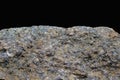 Rock or stone on black background. Granite crouan rim or pick edge like cliff or mountain. Geology mineral texture isolated closeu