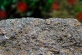 Rock or stone on blurred bokeh background with red spots. Granite crouan rim or pick edge like cliff or mountain. Geology mineral Royalty Free Stock Photo