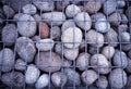 Rock stones behind metal grid fence texture background hd