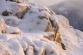 Rock stones covered with ice, snow and icicles on the Yenisei river bank during winter foggy dawn Royalty Free Stock Photo