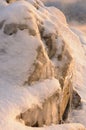 Rock stones covered with ice, snow and icicles on the Yenisei river bank during winter foggy dawn Royalty Free Stock Photo