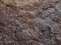 Rock texture: close-up of a red-brown stone useful as background Royalty Free Stock Photo