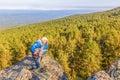 On a rock tourist in a pose of a thinker Royalty Free Stock Photo