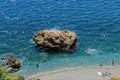 Rock in turquise sea & swimming