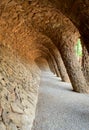 Rock walkway with arch of stone columns in famous Park Guell.