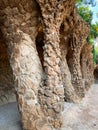 Rock walkway with stone columns in famous Park Guell, designed by Antoni Gaudi. Royalty Free Stock Photo