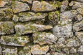 Rock wall built stacked stone moss background Royalty Free Stock Photo