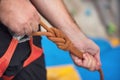 Rock wall climber wearing safety harness and climbing equipment indoor, close-up image Royalty Free Stock Photo