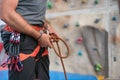 Rock wall climber wearing safety harness and climbing equipment indoor, close-up image Royalty Free Stock Photo