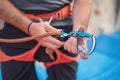 Rock wall climber wearing safety harness and climbing equipment indoor, close-up image Royalty Free Stock Photo