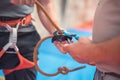 Rock wall climber wearing safety harness and climbing equipment indoor, close-up image Royalty Free Stock Photo