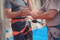 Rock wall climber wearing safety harness and climbing equipment indoor, close-up image Royalty Free Stock Photo