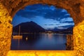 Rock window over tranquil lake Como at dusk