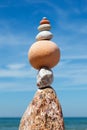 Rock zen Pyramid of balanced stones against the background of the sea and blue sky Royalty Free Stock Photo