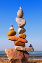 Rock zen Pyramid of balanced stones against the background of the sea and blue sky Royalty Free Stock Photo