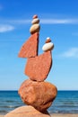 Rock zen Pyramid of balanced stones against the background of the sea and blue sky Royalty Free Stock Photo