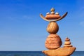 Rock zen Pyramid of balanced stones against the background of the sea and blue sky Royalty Free Stock Photo