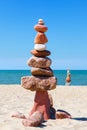 Rock zen pyramid of colorful pebbles on the background of the sea. Concept of balance, harmony and meditation Royalty Free Stock Photo